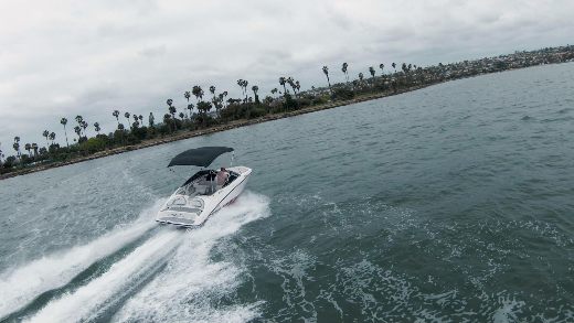 A man boating on the water with a Kemimoto bimini top