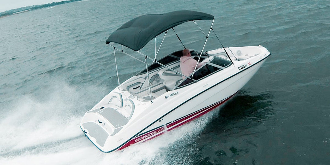speedboat with bimini top on the water