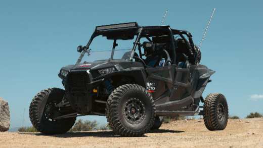  A Polaris RZR with Kemimoto Logo parked on the road