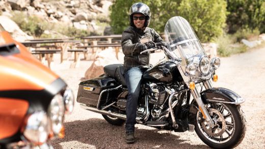 A man sitting on his Harley-Davidson Touring Motorcycle