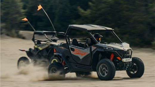 Two men racing CFMoto ZForce 950s on the beach-1