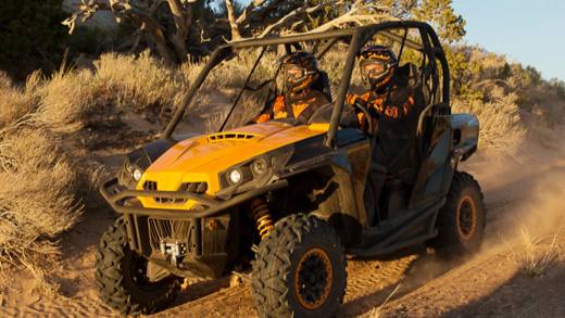 Two men riding Can-Am Commander on the road