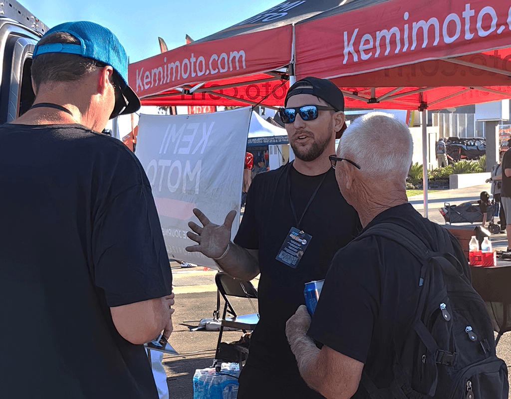 Kemimoto team interacting with riders at the Kemimoto booth during the Sand Sports Super Show and US off-road event tour.